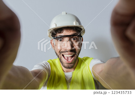 Smiling male engineer taking a selfie looking at camera. Funny builder engineer taking a selfie isolated, Engineer taking a selfie isolated. View of male engineer taking a selfie isolated Smiling male engineer taking a selfie looking at camera. Funny builder engineer taking a selfie isolated, Engineer taking a selfie isolated. View of male engineer taking a selfie isolated 123435733