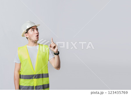 Engineer man pointing up. Surprised face engineer pointing finger to the right, Surprised engineer pointing to the side, Surprised face construction worker pointing at an advertisement 123435769