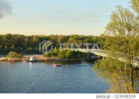 A picturesque view of a serene river accompanied by a bridge and a beautiful scenic landscape A picturesque view of a serene river accompanied by a bridge and a beautiful scenic landscape 123436524