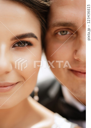 the groom in a brown suit and the bride in a white dress the groom in a brown suit and the bride in a white dress 123436815