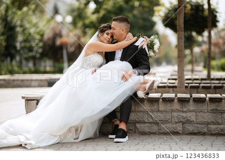 the groom in a brown suit and the bride in a white dress the groom in a brown suit and the bride in a white dress 123436833