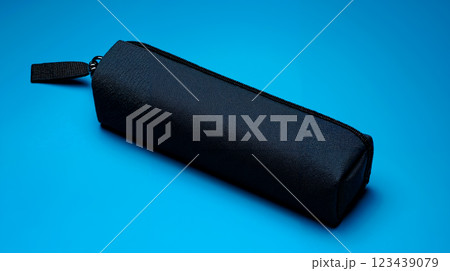 A black pencil case on a blue background A black pencil case on a blue background 123439079