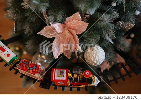 Enjoy a festive Christmas Tree Decor with a charming Train and lovely Ornaments 123439170