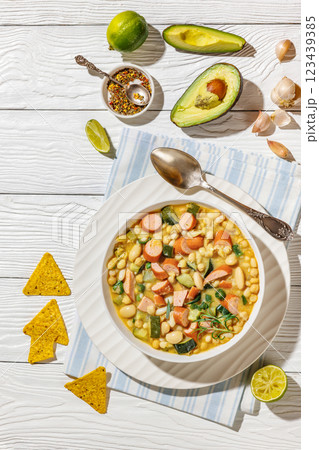 white bean chickpea chili with sausages, zucchini white bean chickpea chili with sausages, zucchini 123439385