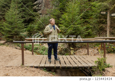 Young 30s blonde man hiking in nature. Travel, adventure. Concept of an active lifestyle. High quality photo. Fall autumn hiker man outdoor at nature forest. Full body Young 30s blonde man hiking in nature. Travel, adventure. Concept of an active lifestyle. High quality photo. Fall autumn hiker man outdoor at nature forest. Full body 123441414