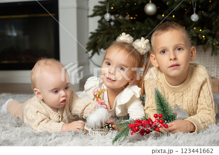 Small children brothers and sisters at the Christmas tree. Children on Christmas Eve. 123441662