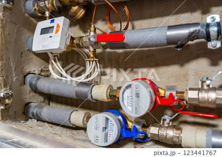 Smart water and heat meters with remote data transmission installed in a European utility system. The concept represents modern energy efficiency and digital infrastructure development Smart water and heat meters with remote data transmission installed in a European utility system. The concept represents modern energy efficiency and digital infrastructure development 123441767