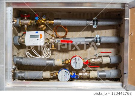 Smart water and heat meters with remote data transmission installed in a European utility system. The concept represents modern energy efficiency and digital infrastructure development Smart water and heat meters with remote data transmission installed in a European utility system. The concept represents modern energy efficiency and digital infrastructure development 123441768
