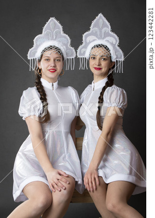 Two Russian Girls in a Snow Maiden costume posing on a gray background. 123442281
