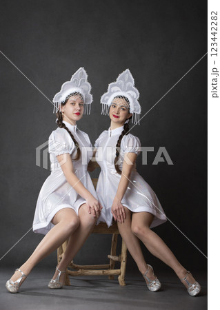 Two Russian Girls in a Snow Maiden costume posing on a gray background. 123442282