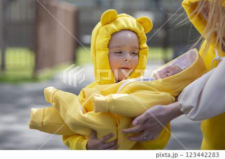 Happy little girl holding her newborn brother or sister in her arms. Meeting with the maternity hospital. 123442283