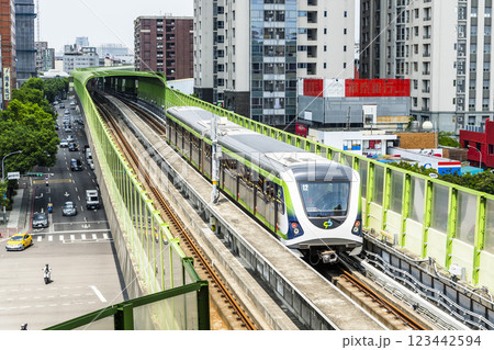 A Green Line train running on the elevated track of the Taichung Rapid Transit System in Taiwan.  123442594