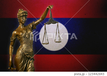 Lady Justice before a flag of Laos Lady Justice before a flag of Laos 123442843
