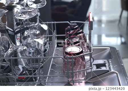 Wine glasses in dishwasher. Clean and tidy. Organizing dishes on holder, loading dirty items. Wine glasses in dishwasher. Clean and tidy. Organizing dishes on holder, loading dirty items. 123443420