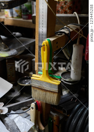 A Colorful Brush is centered in a Creative Workspace filled with artistic tools and supplies 123445288