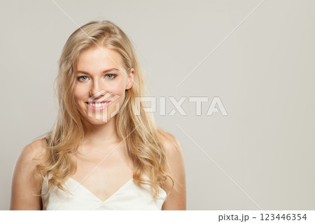 Happy blond woman with cute smile looking at camera. Beauty young adult person portrait 123446354