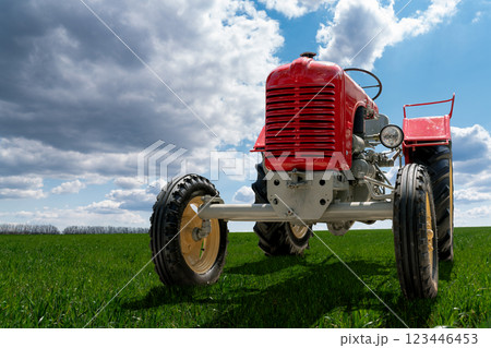 Retro tractor on the field near the farm Retro tractor on the field near the farm 123446453