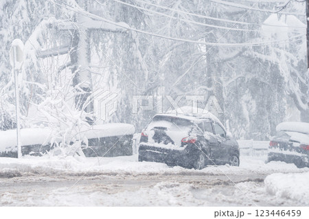 Parked car covered with snow during snow storm 123446459