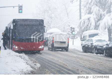 City bus on a city street during snowfall City bus on a city street during snowfall 123446466