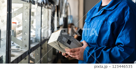 Worker works in a spare parts warehouse 123446535