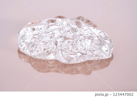 Beautiful volumetric texture of cosmetic gel on a powdery pink background. 123447002