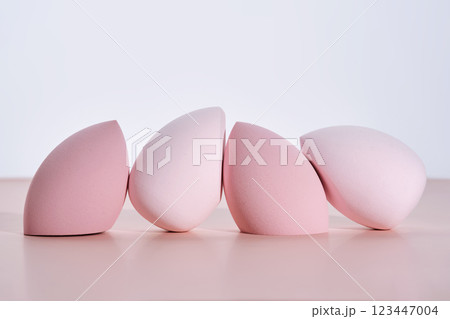 A set of makeup sponges on a pink background. 123447004