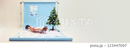 Man in fur hat and shorts, lying on sled like superhero in snow. Extreme leisure and absurd fun. Concept of carefree winter vacation Man in fur hat and shorts, lying on sled like superhero in snow. Extreme leisure and absurd fun. Concept of carefree winter vacation 123447097