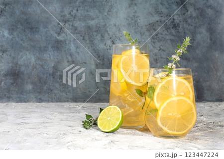 Detox drink with lemon, mint, lime and orange on a dark table, cocktail improves metabolism and promotes weight loss, healthy lifestyle concept, selective focus Detox drink with lemon, mint, lime and orange on a dark table, cocktail improves metabolism and promotes weight loss, healthy lifestyle concept, selective focus 123447224