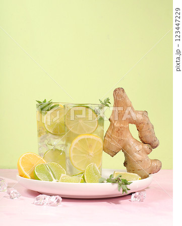 Detox drink with lemon, mint, lime and orange on a light table, mojito or cocktail improves metabolism and promotes weight loss and strengthens immunity, healthy lifestyle concept, selective focus 123447229