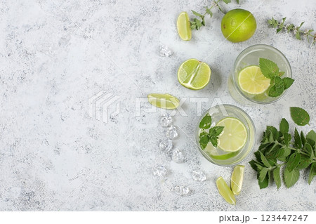 Detox drink with mint, lime and orange on a light table, majito or cocktail improves metabolism and promotes weight loss, healthy lifestyle concept, selective focus 123447247