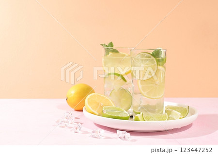 Detox drink with lemon, mint, lime and orange on a light table, majito or cocktail improves metabolism and promotes weight loss, healthy lifestyle concept, selective focus Detox drink with lemon, mint, lime and orange on a light table, majito or cocktail improves metabolism and promotes weight loss, healthy lifestyle concept, selective focus 123447252