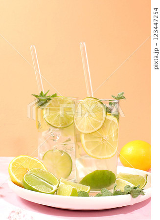Detox drink with lemon, mint, lime and orange on a light table, majito or cocktail improves metabolism and promotes weight loss, healthy lifestyle concept, selective focus Detox drink with lemon, mint, lime and orange on a light table, majito or cocktail improves metabolism and promotes weight loss, healthy lifestyle concept, selective focus 123447254