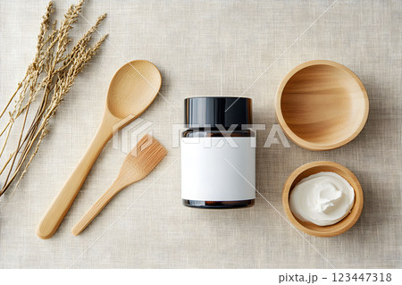Natural skin therapy cosmetic jar on a neutral fabric background with utensils for aromatherapy and organic extracts 123447318