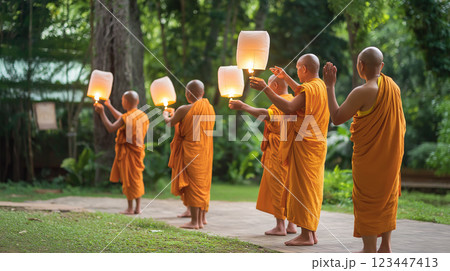 Buddhist monks lighting lanterns for Vesak 123447413