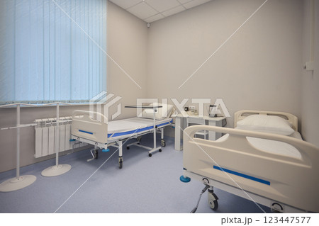 A Hospital Bed located within a Medical Facility designed for patient comfort and care A Hospital Bed located within a Medical Facility designed for patient comfort and care 123447577