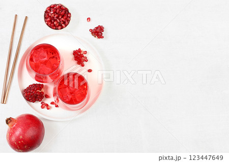 Fruit juice and ingredients, pomegranate summer drink on a bright table, detox diet and weight loss concept, healthy and natural food, vitamin C source, selective focus, space for text Fruit juice and ingredients, pomegranate summer drink on a bright table, detox diet and weight loss concept, healthy and natural food, vitamin C source, selective focus, space for text 123447649