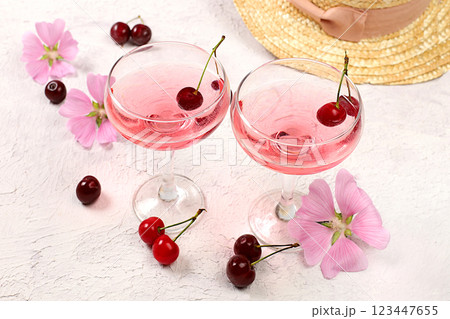 Summer fashion banner on a bright background. Straw hat, fruits in an eco-bag, refreshing alcoholic drinks and chamomile flowers on a sunny table. Vacation and travel concept, outdoor camping and Summer fashion banner on a bright background. Straw hat, fruits in an eco-bag, refreshing alcoholic drinks and chamomile flowers on a sunny table. Vacation and travel concept, outdoor camping and 123447655