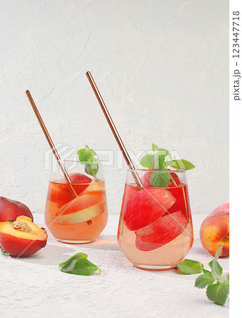 The concept of detox diet and body cleansing. Refreshing homemade lemonade cocktail with fresh apples, peaches and mint. Fruit juice and ingredients, weight loss concept, healthy and natural food, The concept of detox diet and body cleansing. Refreshing homemade lemonade cocktail with fresh apples, peaches and mint. Fruit juice and ingredients, weight loss concept, healthy and natural food, 123447718