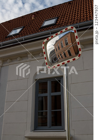Orange classic building in a traffic mirror, Czechia Orange classic building in a traffic mirror, Czechia 123447937