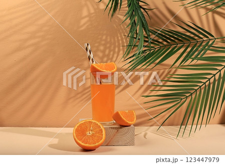 Modern still life with citrus fruits, orange juice and oranges on a pastel background with long hard shadows, minimal detox diet concept, summer vitamin drinks, selective focus, space for text Modern still life with citrus fruits, orange juice and oranges on a pastel background with long hard shadows, minimal detox diet concept, summer vitamin drinks, selective focus, space for text 123447979
