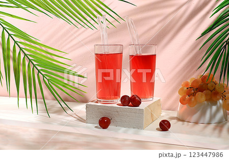 Modern still life with grape juice and grapes on pastel background with shadows, minimal detox diet concept, summer party advertisement with vitamin drinks, selective focus, space for text 123447986