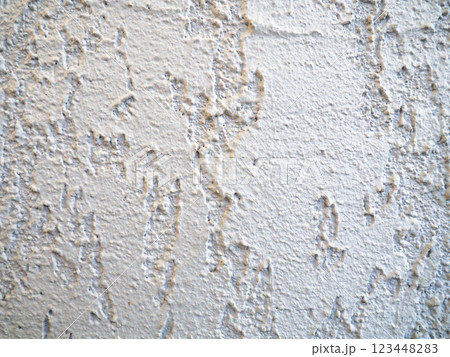 Rough light surface. Background from a stone wall. Cement stains. House cladding. 123448283