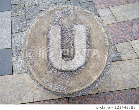 Letter U  made of stone. Carved letter U in concrete. Alphafit cast from concrete. The concept of the letter U. 123448385