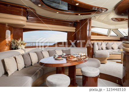 An Elegant Yacht Interior Featuring Luxurious Seating and Beautiful Scenic Views Everywhere An Elegant Yacht Interior Featuring Luxurious Seating and Beautiful Scenic Views Everywhere 123448510