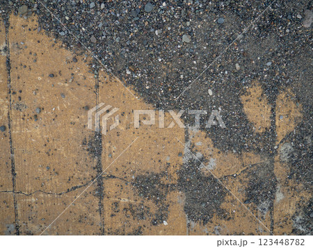 Background of brown tiles and small pebbles. Solid material pattern. Pebbles on tiles. Sidewalk surface in the park. Cracks. 123448782