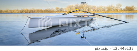 Coastal rowing shell by on a lake in northern Colorado in winter or early spring scenery. 123449135