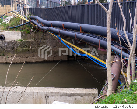 Communications go under the bridge on the river. Wires and pipes under the bridge. Gas pipeline electricity. 123449360