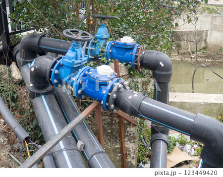 Gas pipes with valves on the street. Communications in the city. Gas pipeline on the street. Black pipes. Gas pipes with valves on the street. Communications in the city. Gas pipeline on the street. Black pipes. 123449420