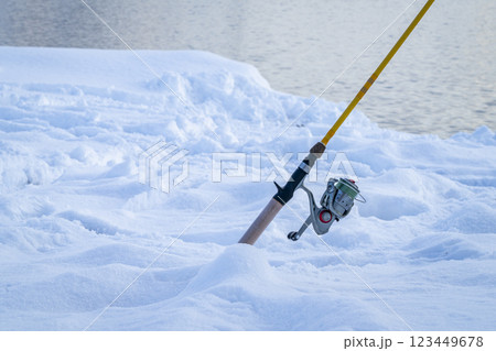 fishing rod on a snowy lake shore - partially frozen Horsetooth Reservoir 123449678