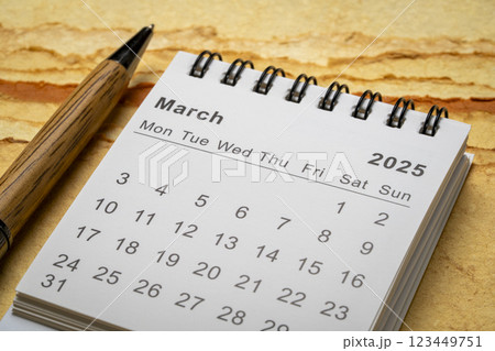 March 2025 - small spiral desktop calendar, time and business concept 123449751